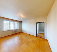 A room in a 3-room apartment with a window and a floor with a wooden decor.