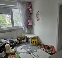 Children's room in a 4-room apartment with wall decor and toys.