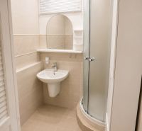 Bathroom with a shower and a sink in a 3-room apartment with tiles.