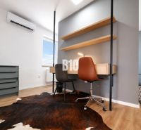 A work corner in a recreational apartment with a carpet touch and a wooden decor floor.