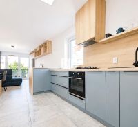 Kitchen in the Holiday Apartment with wood-patterned flooring and garden view.