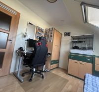 Home office in a 4-room apartment with wood-decor flooring, a desk, and a chair.