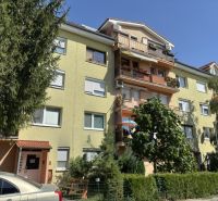 A four-story apartment building with balconies on Družstevná Street in Bernolákovo.