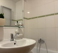 A bathroom with sanitary ceramics and beige tiles in a 4-room apartment.