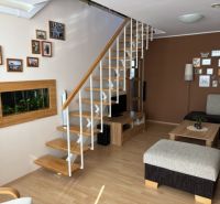 Living room with stairs, wooden decor flooring, and wall decoration in a 4-room apartment.