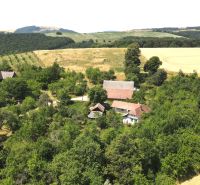 A family house in the village of Vrbovce on Kamenec Street, surrounded by greenery and fields.