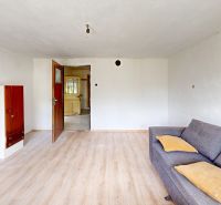 Living room in a family house with a sofa and wooden decor flooring.