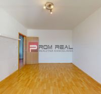 A room in a 3-room apartment with a wooden decor floor and spot lighting.