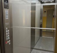 The interior of an elevator in a 3-room apartment with modern lighting and a control panel.