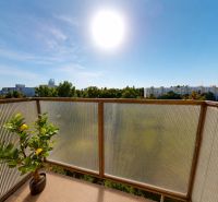 A balcony in a 3-room apartment on Šándorova Street with a view of greenery in Bratislava.