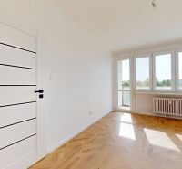 A bright room in a 3-room apartment with access to a balcony and a floor with a wooden decor.