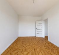Spacious room in a 3-room apartment with a wooden decor floor.