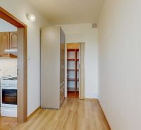 Interior of a 3-room apartment with a kitchen and a floor with a wooden decor.