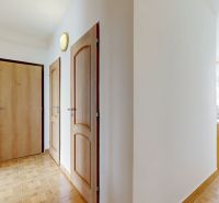 A hallway in a 3-room apartment with a wooden decor floor and a dining area.