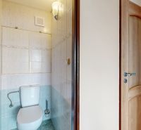 A toilet with tiles in a 3-room apartment.