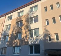 An apartment building in Rožňava offering a 2-room apartment under a clear sky.