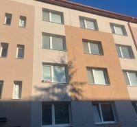The facade of an apartment building in Rožňava offering a 2-room apartment, bright facade shades.