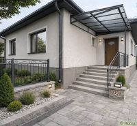 A family house in Šurany with a hallway, staircase, and landscaped garden.