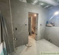 Interior of a family house under construction, with bare walls and unfurnished rooms.