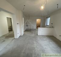 The interior of a family house with plastered walls and a cement floor.