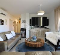 Living room in a holiday apartment with comfortable sofas and a television.