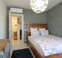 Recreational apartment with a bedroom, wooden decor, and decorative lighting.