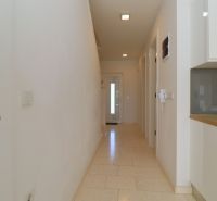Hallway with white walls and tiles, Recreational apartment.