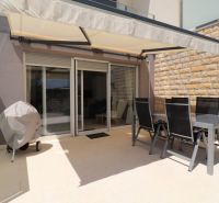 The terrace of a recreational apartment in Tribunj with covered seating and outdoor furniture.