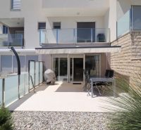 Terrace of a recreational apartment in Tribunj with seating and a grill under an awning.