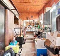 Storage space in a family house with tools and cardboard boxes.