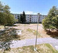 An apartment building surrounded by trees on A. Hlinka Street in Piešťany, near a 4-room apartment.