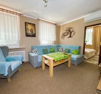 Living room with comfortable seating in a 4-room apartment, entrance to the room.