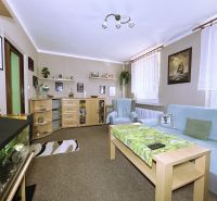 Living room in a 4-room apartment with a sofa, aquarium, and shelves.