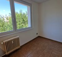 A room in a 3-room apartment with tiles and a large window overlooking greenery.