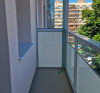 Glazed loggia with tiles in a 3-room apartment, view of the external architecture.