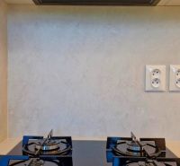 A kitchen unit with a built-in extractor hood and hob in a 3-room apartment.