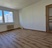 A room in a 3-room apartment with a wooden decor floor and white walls.