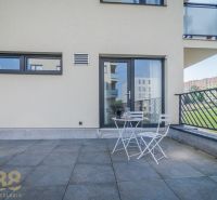 Terrace of a 4-room apartment on Dlhé Hony in Poprad with white seating.