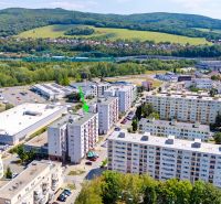 A view of commercial spaces and residential buildings on Dvory Street in Púchov.