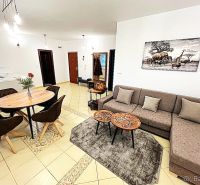 Living room in a 3-room apartment with a dining table and a sofa.
