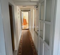 Narrow interior with carpet in a family house, long corridor.