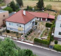 A family house in Šajdíkovce Humence with a landscaped garden and a red roof.