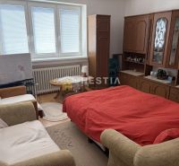 A room in a family house with wooden decor and comfortable furniture.