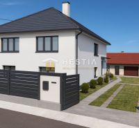 A family house in Šajdíkových Humence with an elegant fence and a landscaped garden.