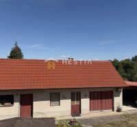 A family house in Šajdíkovce Humence with a red roof and a garage.