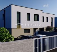 The exterior of two-story houses with a garden and parking in the town of Rovensko.
