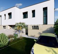 A two-story house in Rovensko with a well-maintained garden and driveway, parked car.
