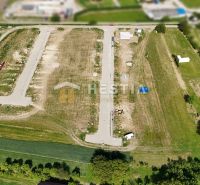 Aerial view of land - housing in Rovensko with divided plots and a road.