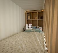 A children's bed with lights and toys in the cozy space of a 3-room apartment.