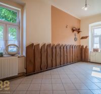 Gastro premises with tiles, decorative wood, and large windows, cozy and bright.